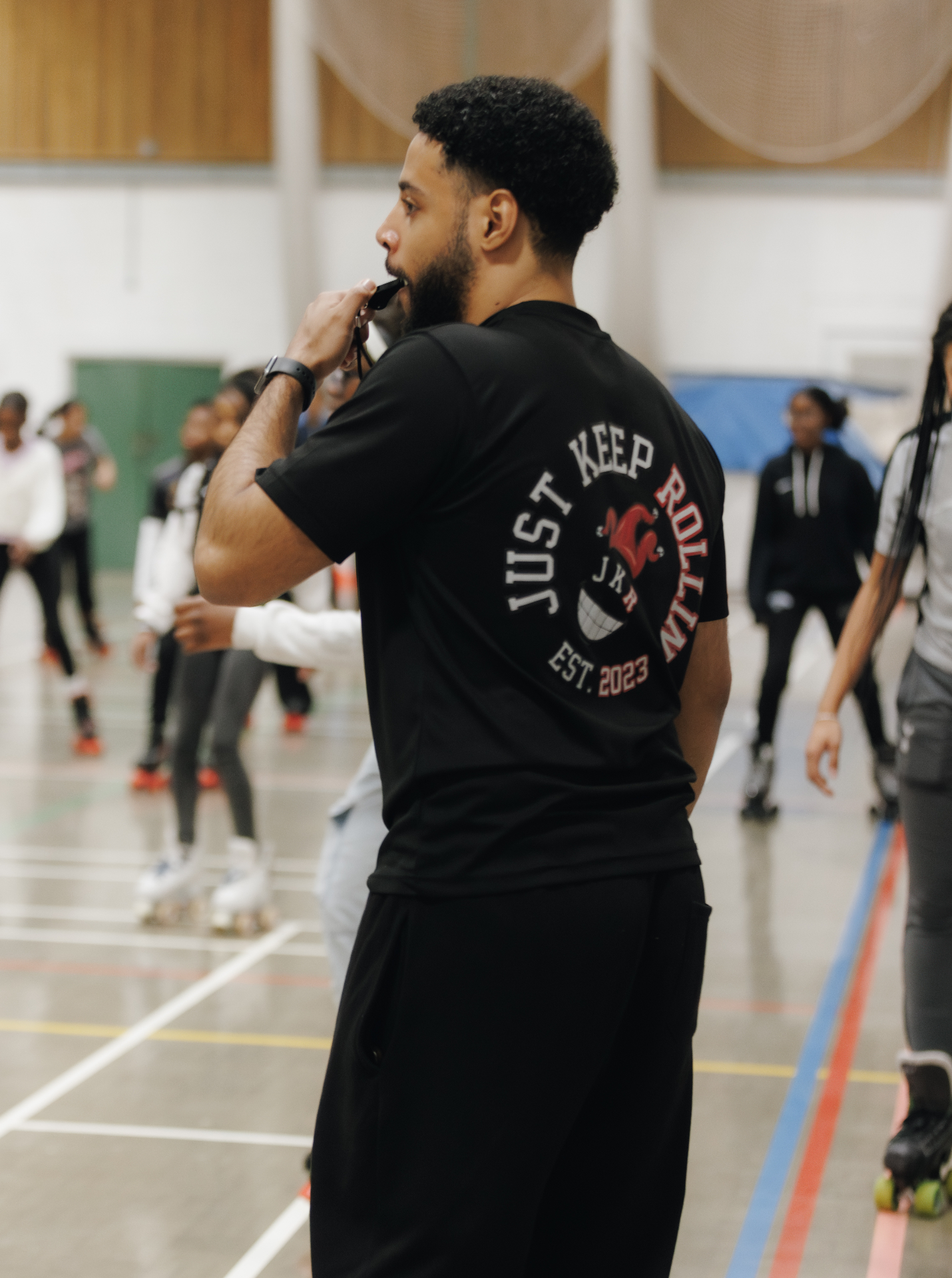 JKR coach overseeing a packed sports-hall skate session